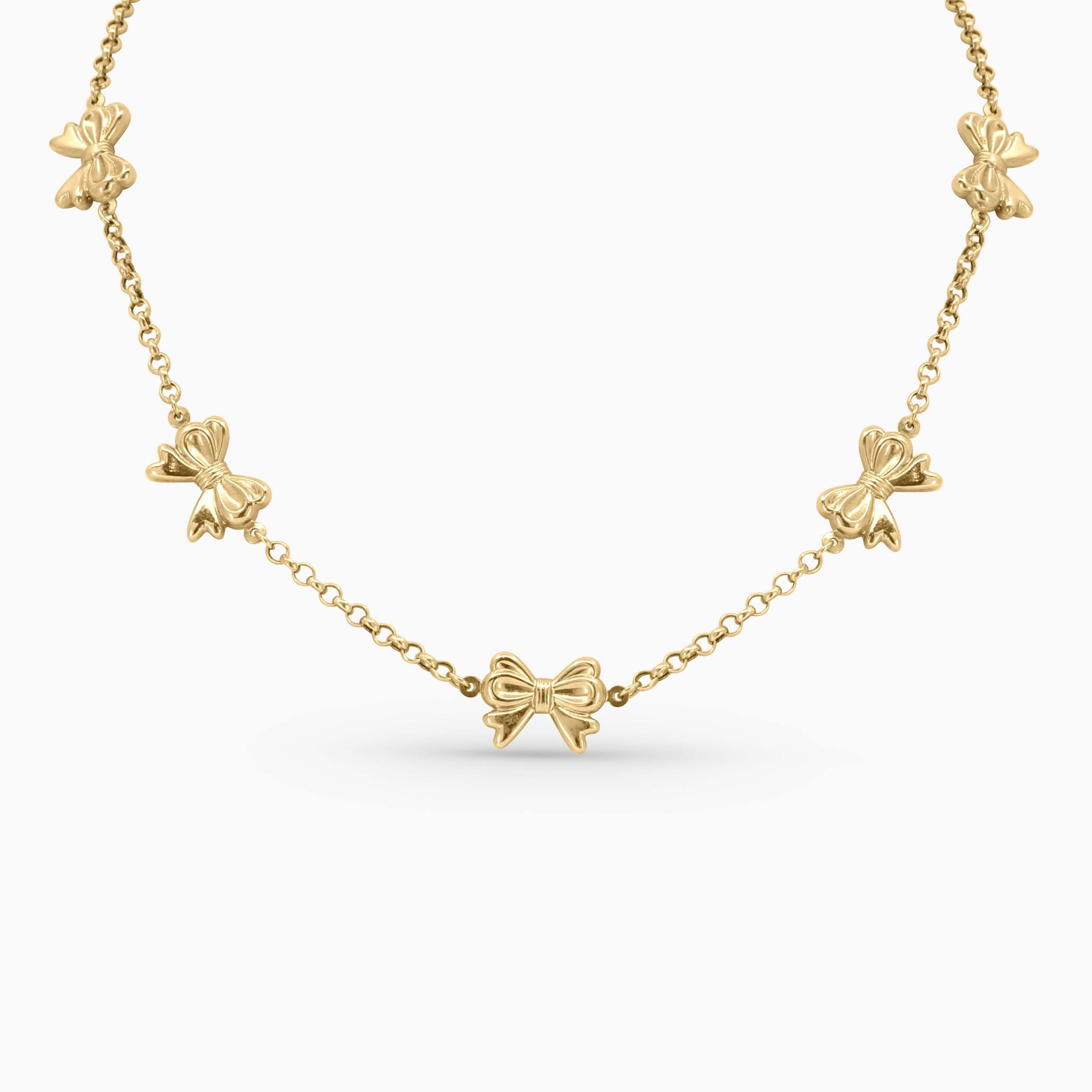 Gold necklace with bow-shaped pendants on a white background