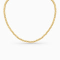 Gold beaded necklace on a white background