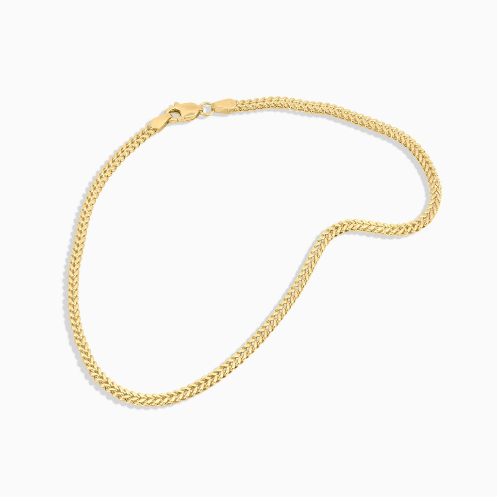 Gold chain bracelet on a white background