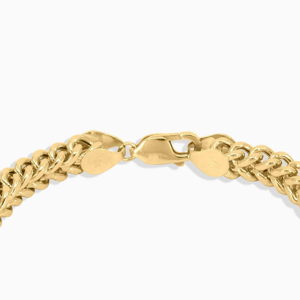 Gold chain bracelet on a white background