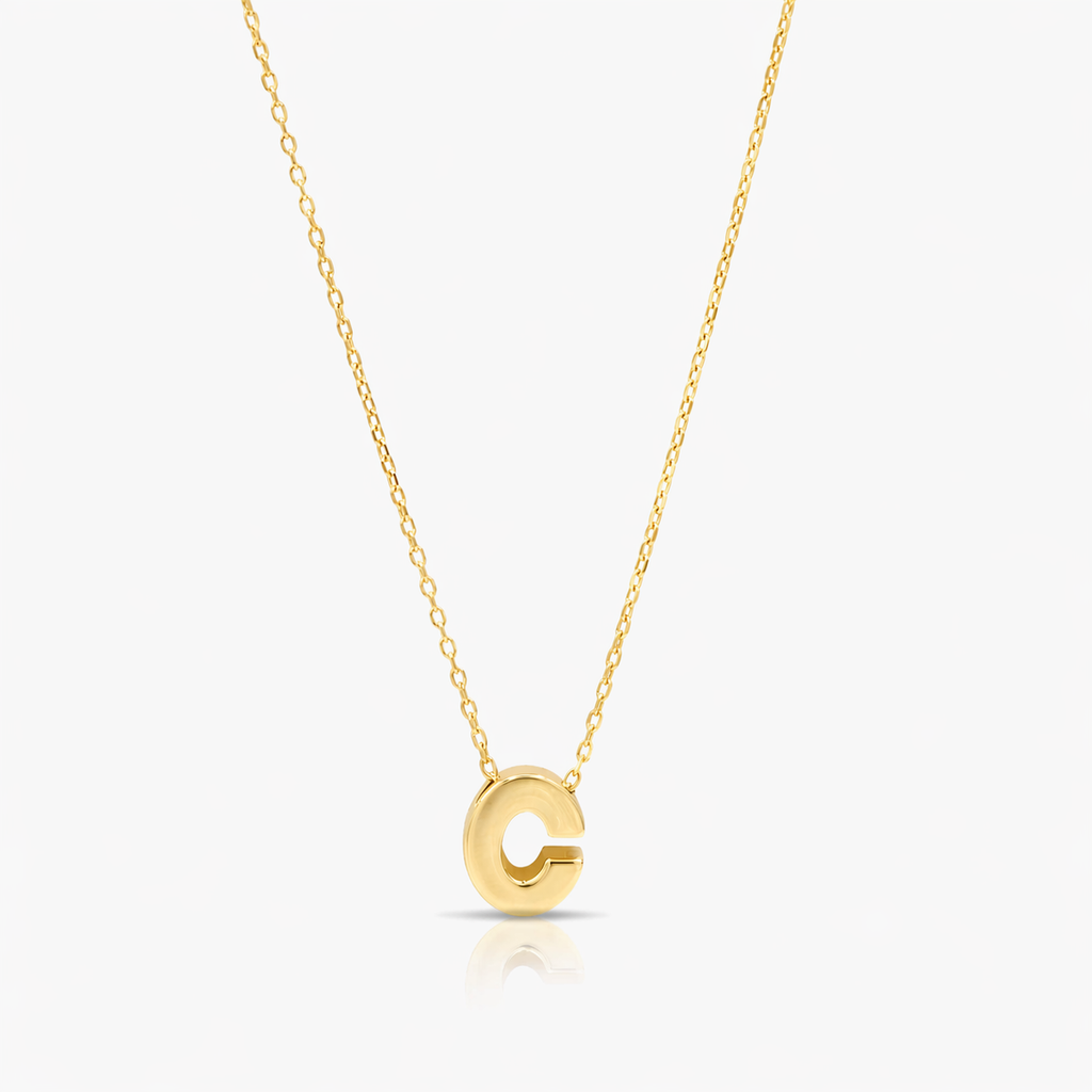 Gold necklace with a 'C' pendant on a white background