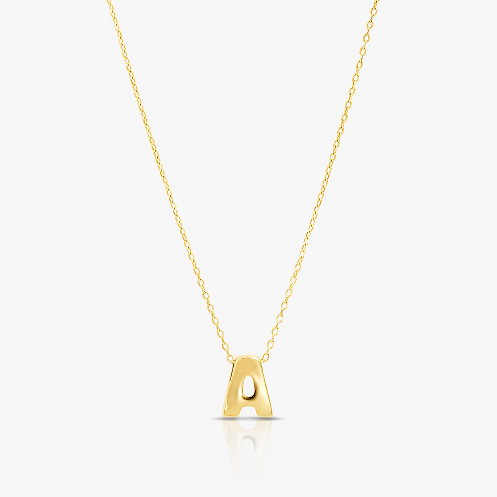 Gold necklace with a letter 'A' pendant on a light gray background