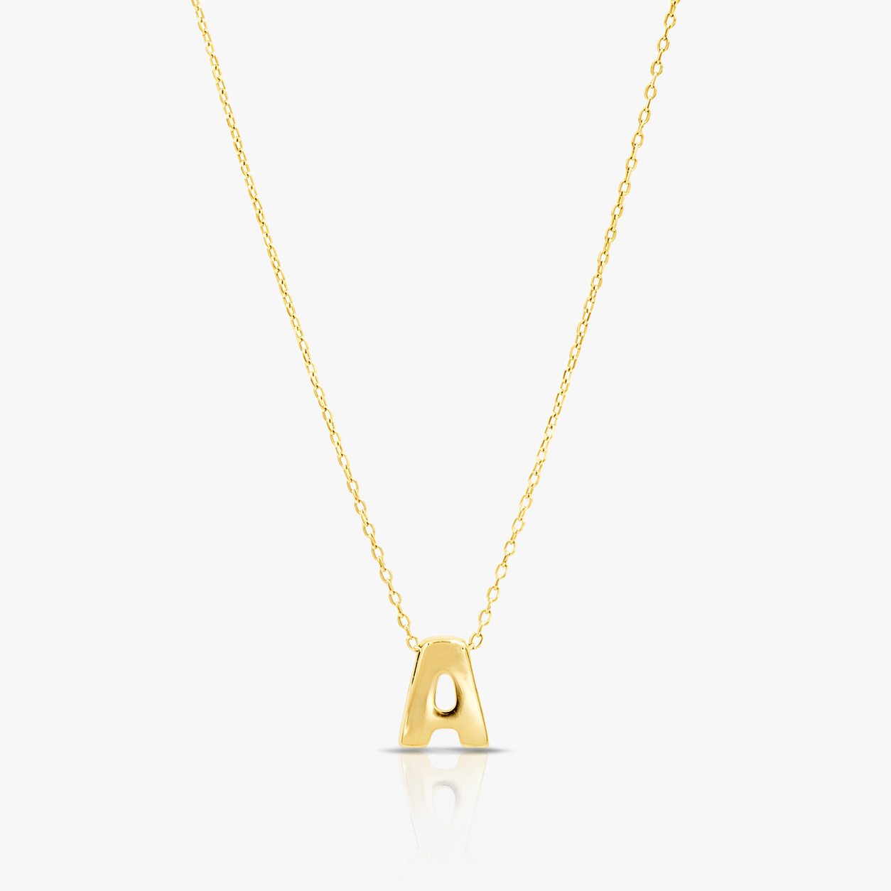 Gold necklace with a letter 'A' pendant on a light gray background