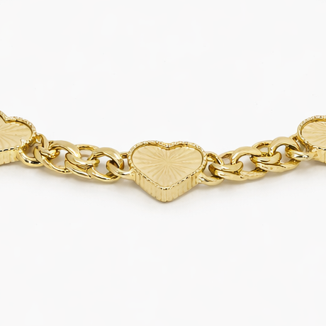 Gold bracelet with heart-shaped links on a white background
